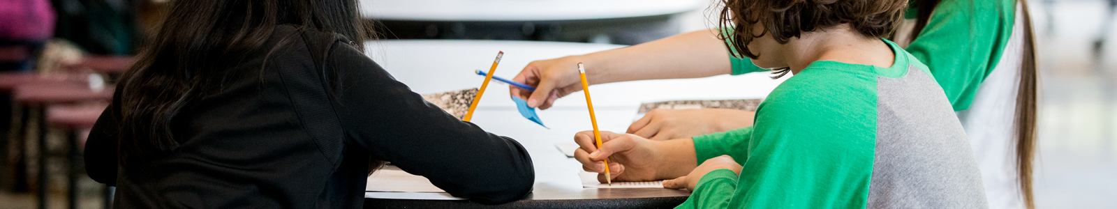 people writing on paper with pencils